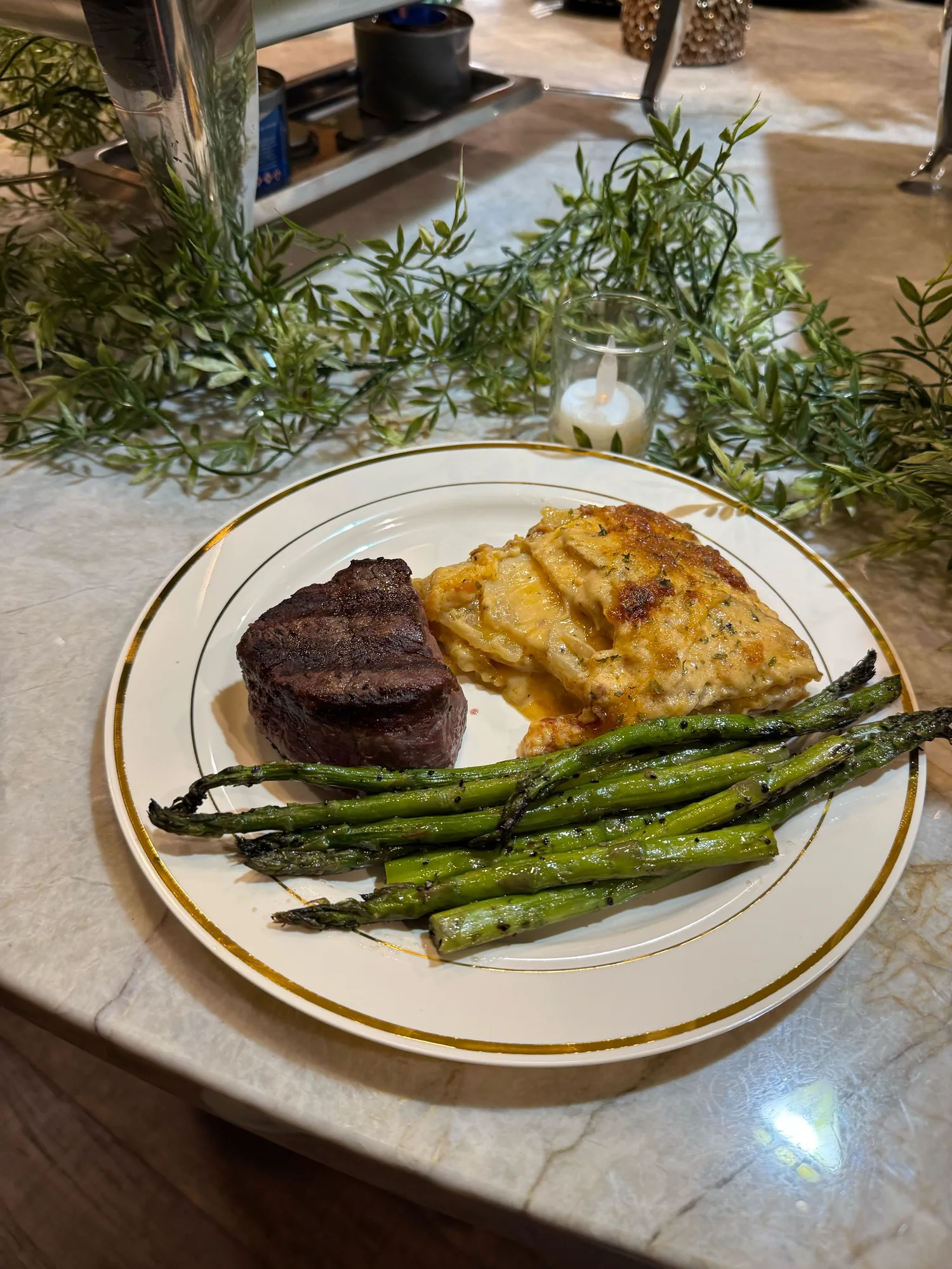 Plated filet, au gratin potatoes, and grilled asparagus