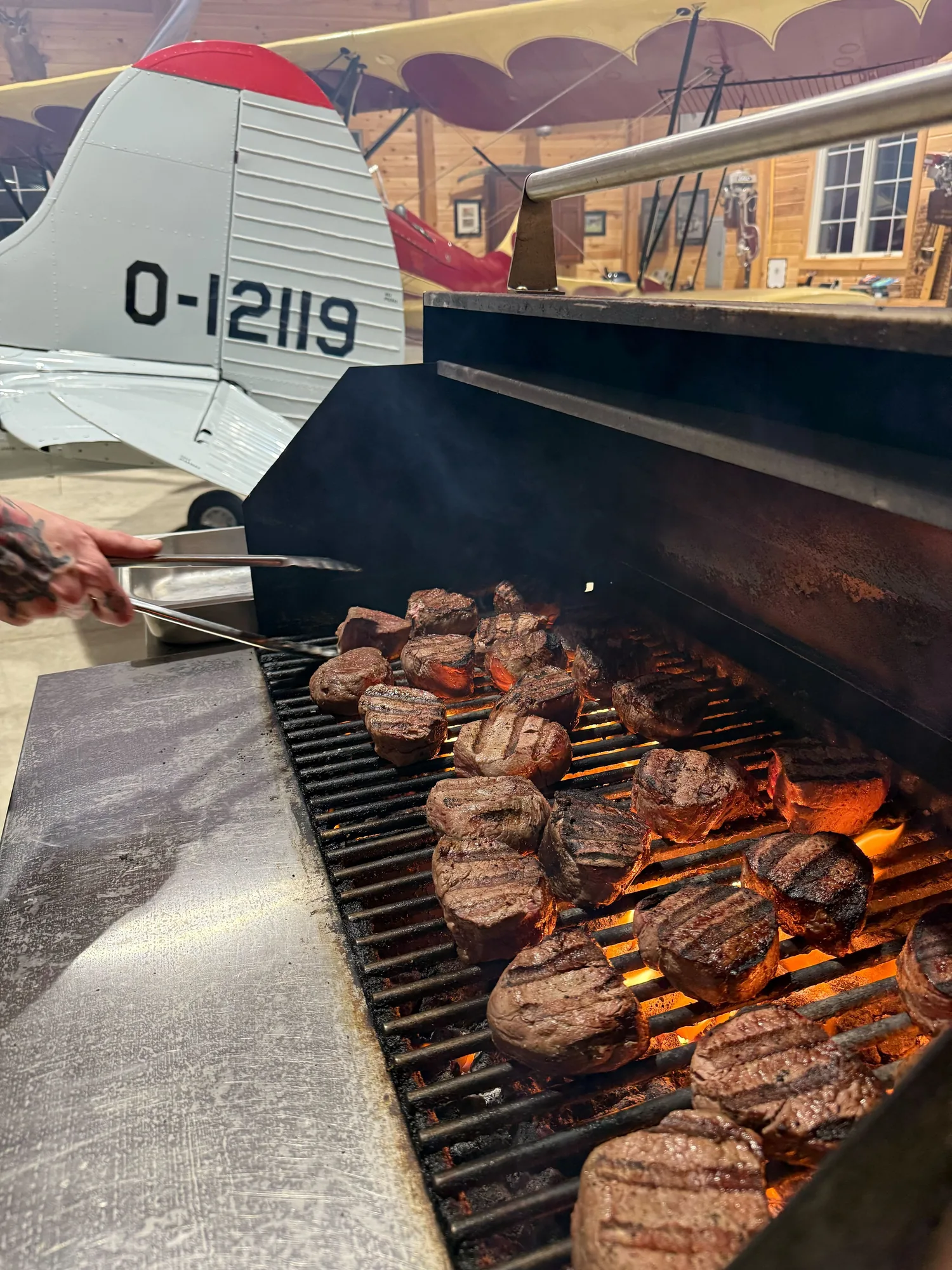 Seasoned steaks searing on the grill
